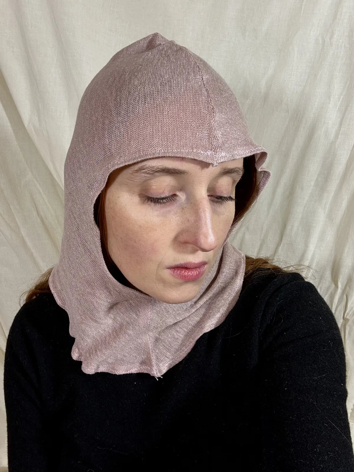 model wears silk knitted lilac hood against white backdrop