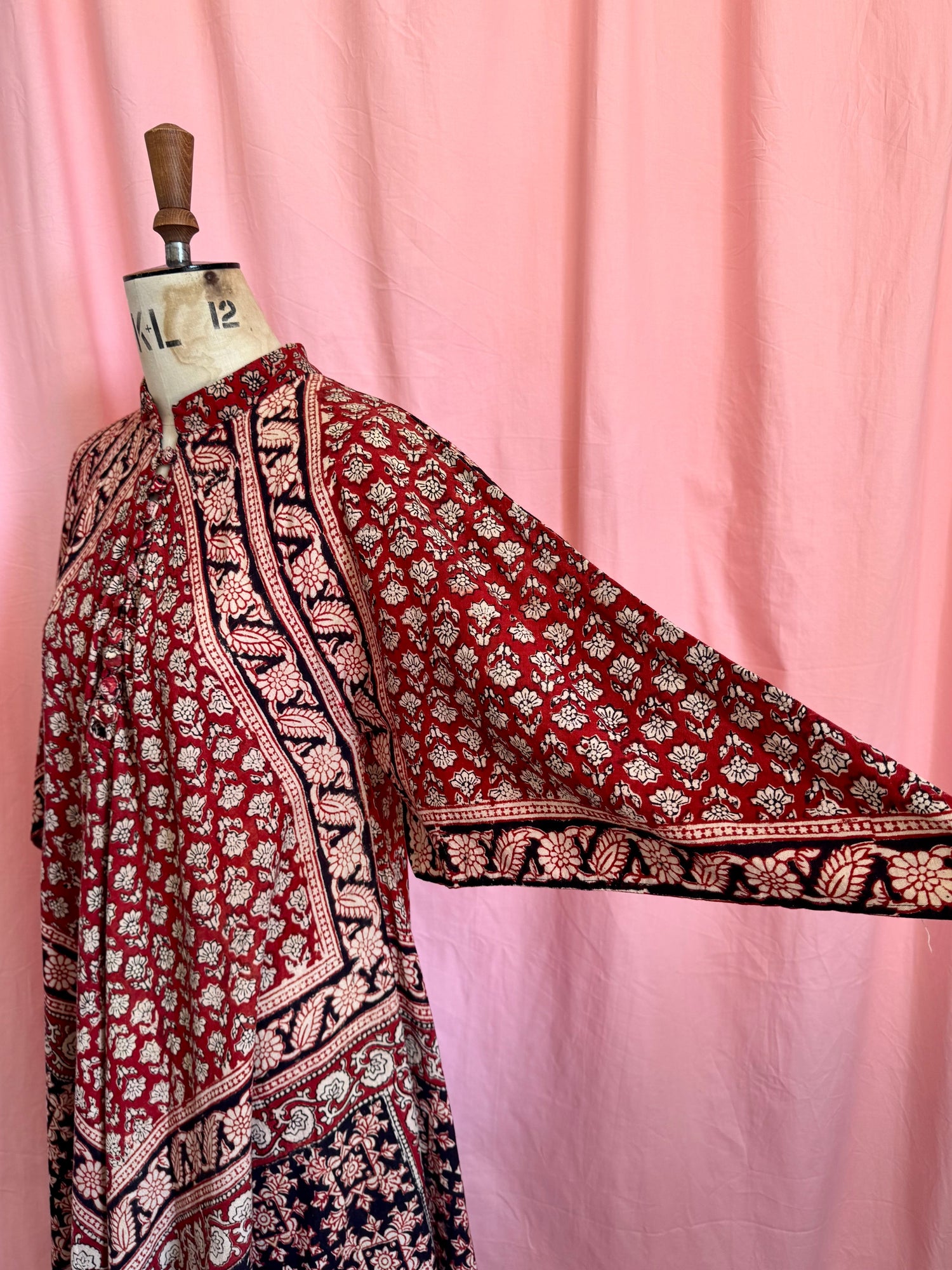 Vintage Indian thick cotton yellow dress with patchwork detail on plain background