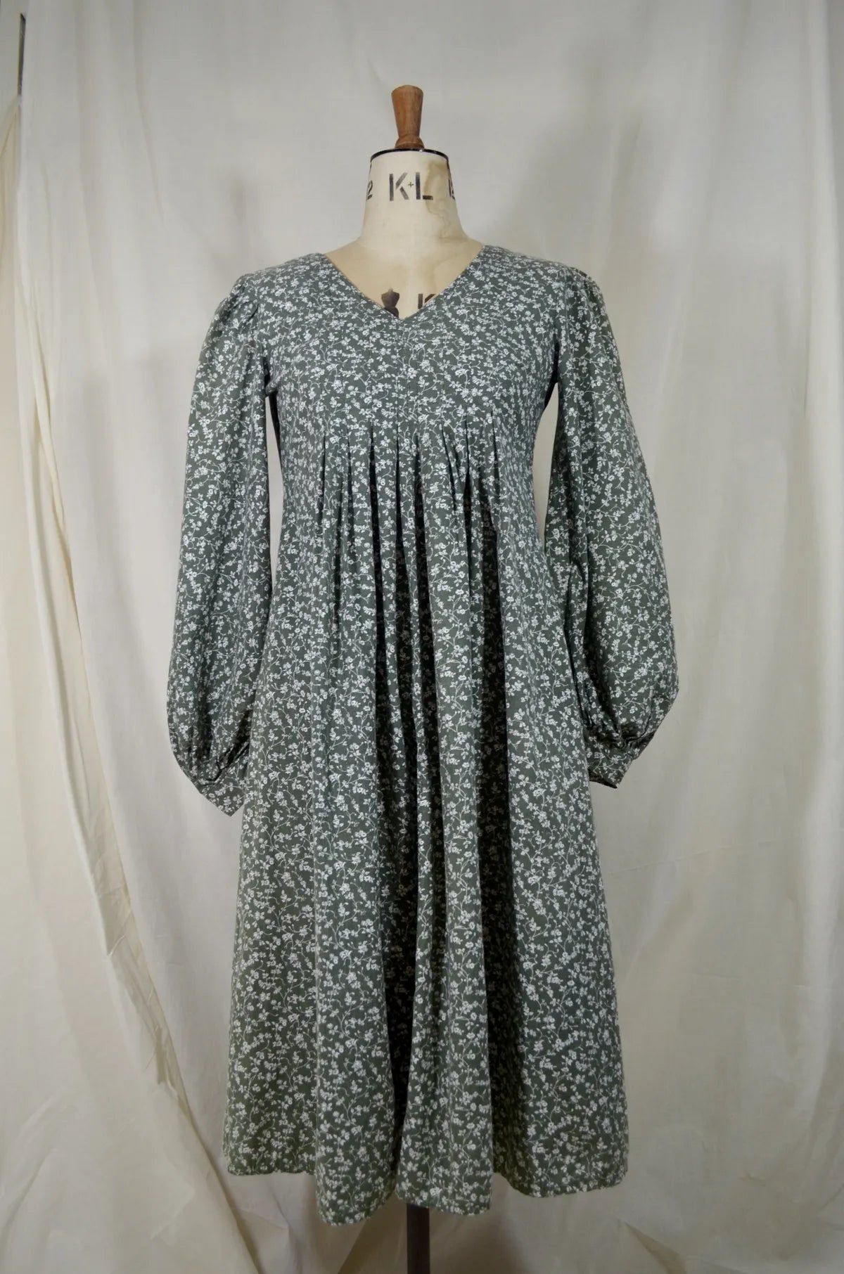 Floral dress on a mannequin against a white background