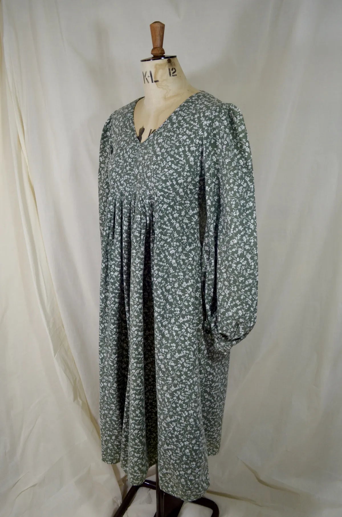 Floral dress on a mannequin against a white background