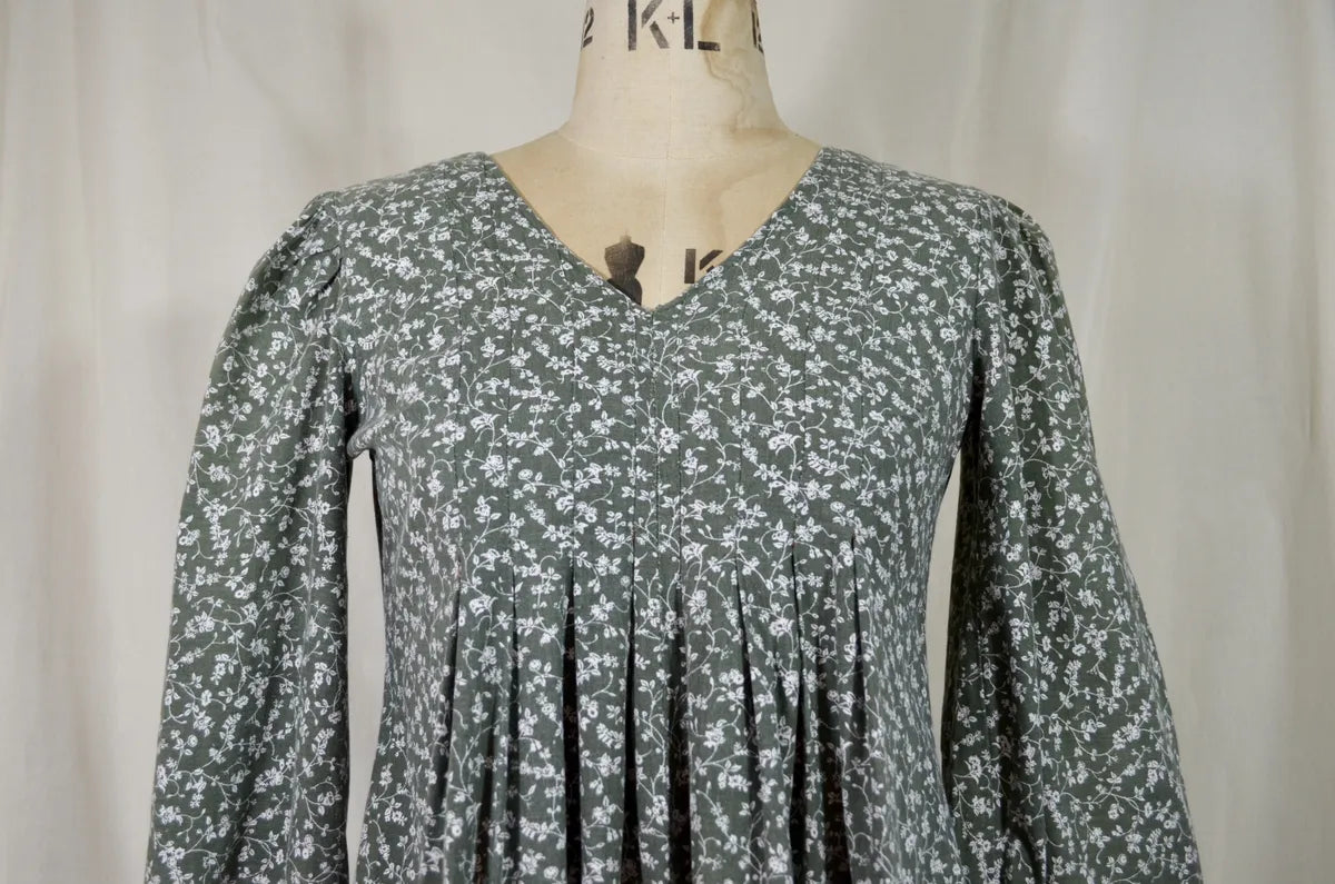 Floral dress on a mannequin against a plain background