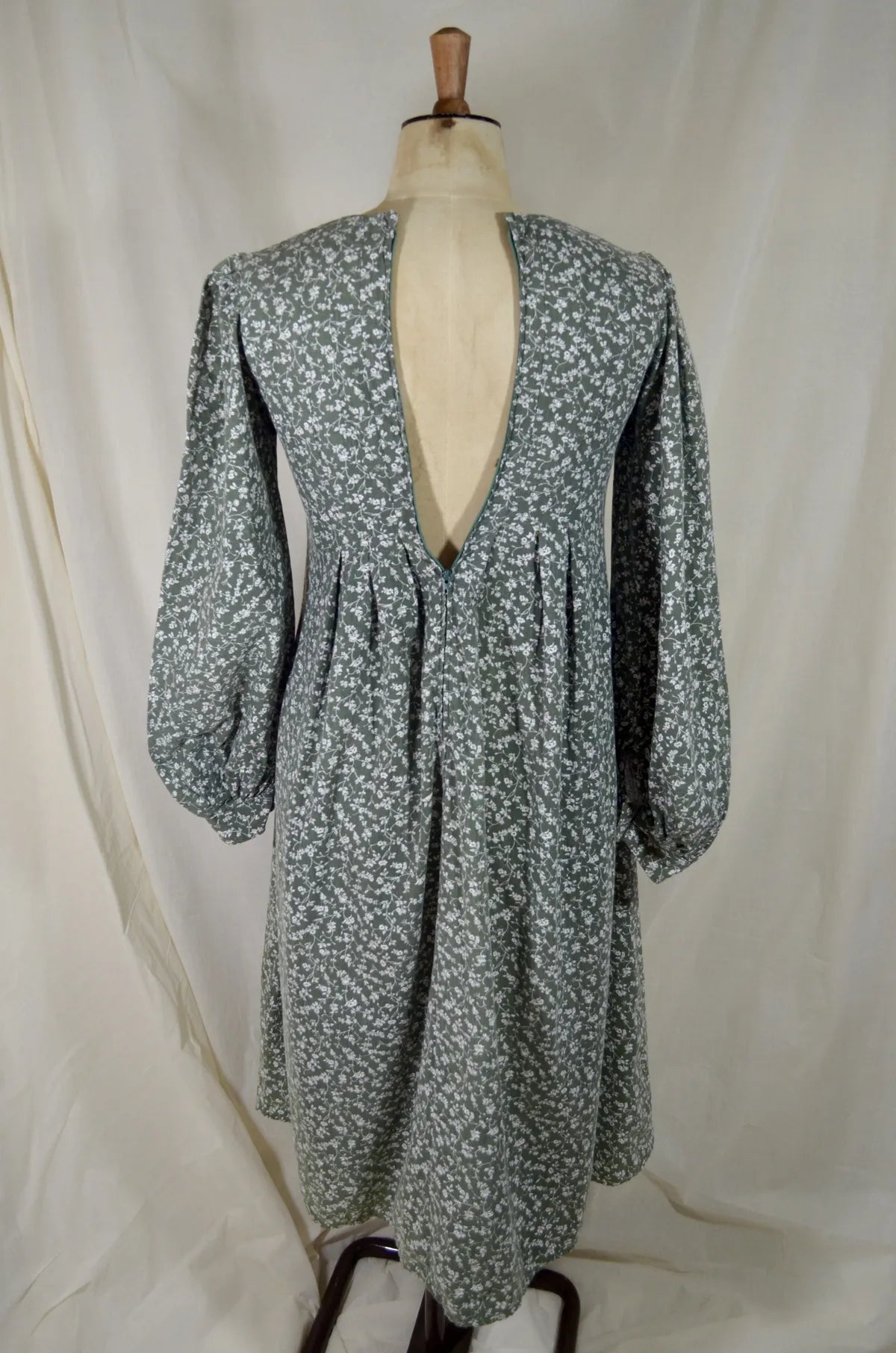 Floral dress on a mannequin against a white background