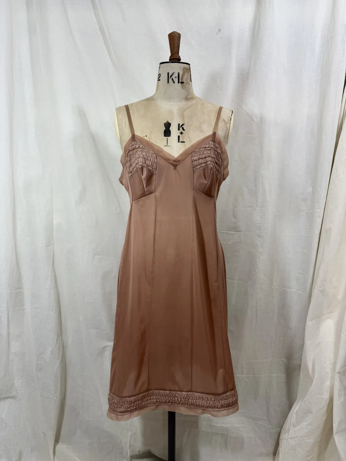 Brown satin nightgown on a mannequin with a white background