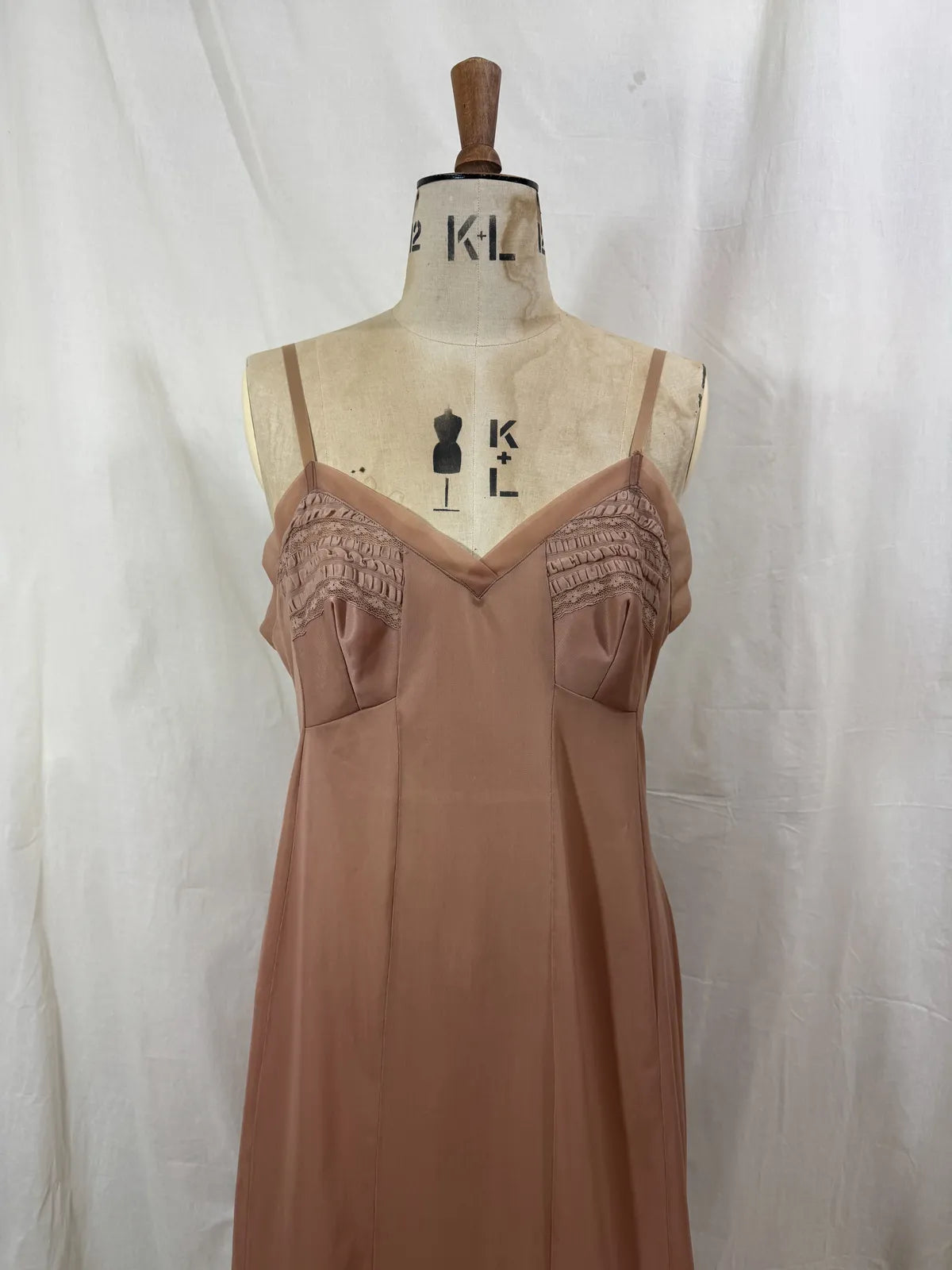 Brown satin nightgown on a mannequin with a white background