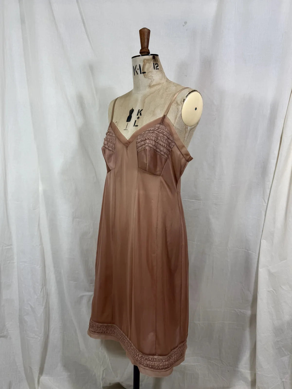 Brown satin nightgown on a mannequin with a white background