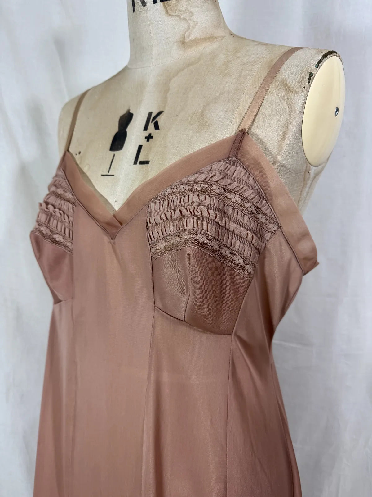 Brown satin nightgown on a mannequin with a white background