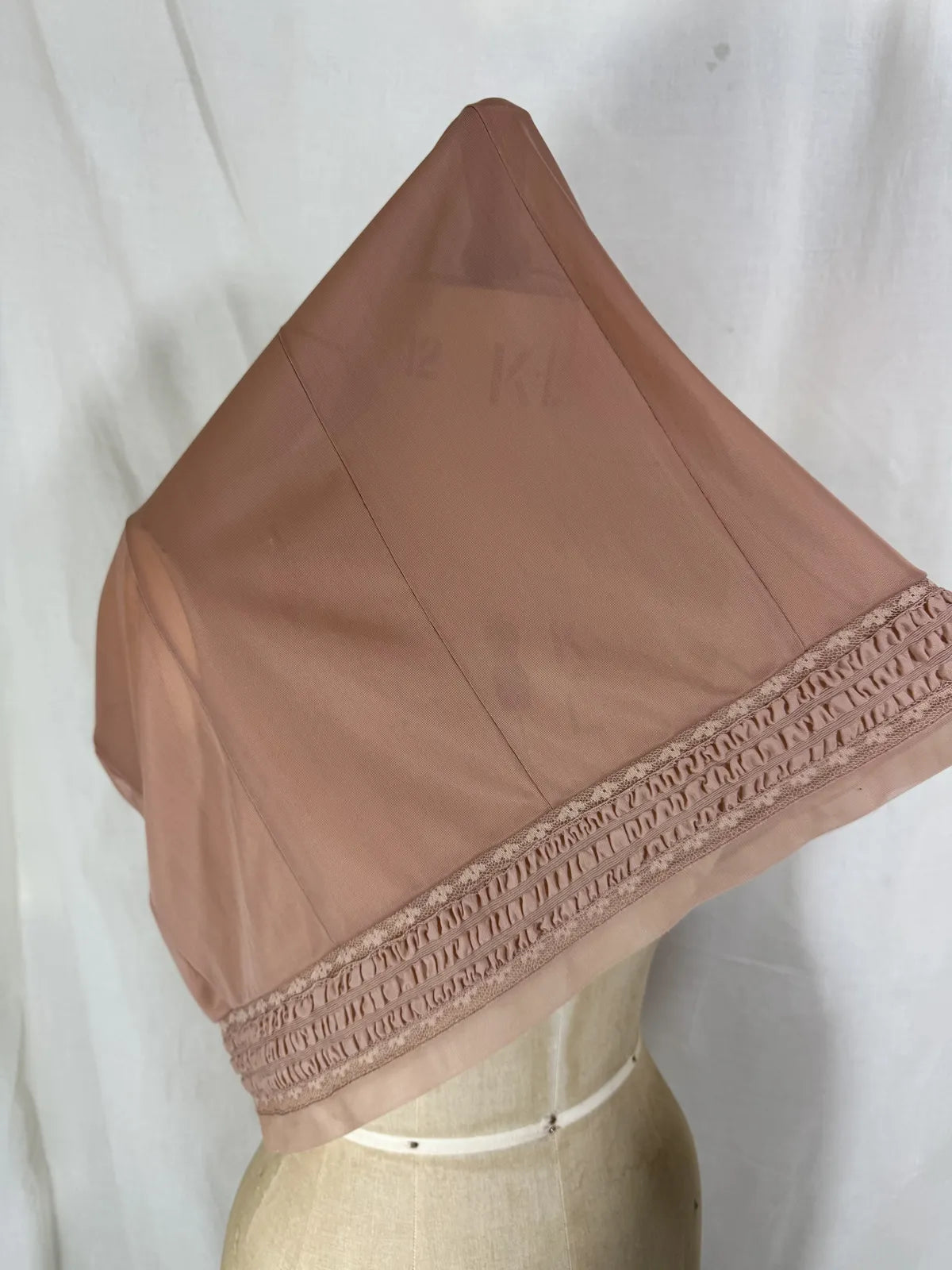 Brown satin nightgown on a mannequin with a white background
