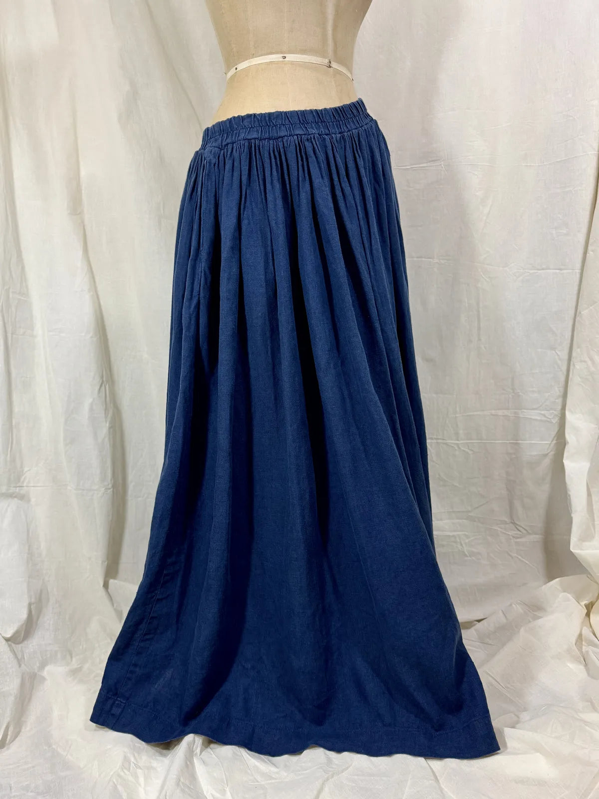 Navy blue skirt on a mannequin against a white background