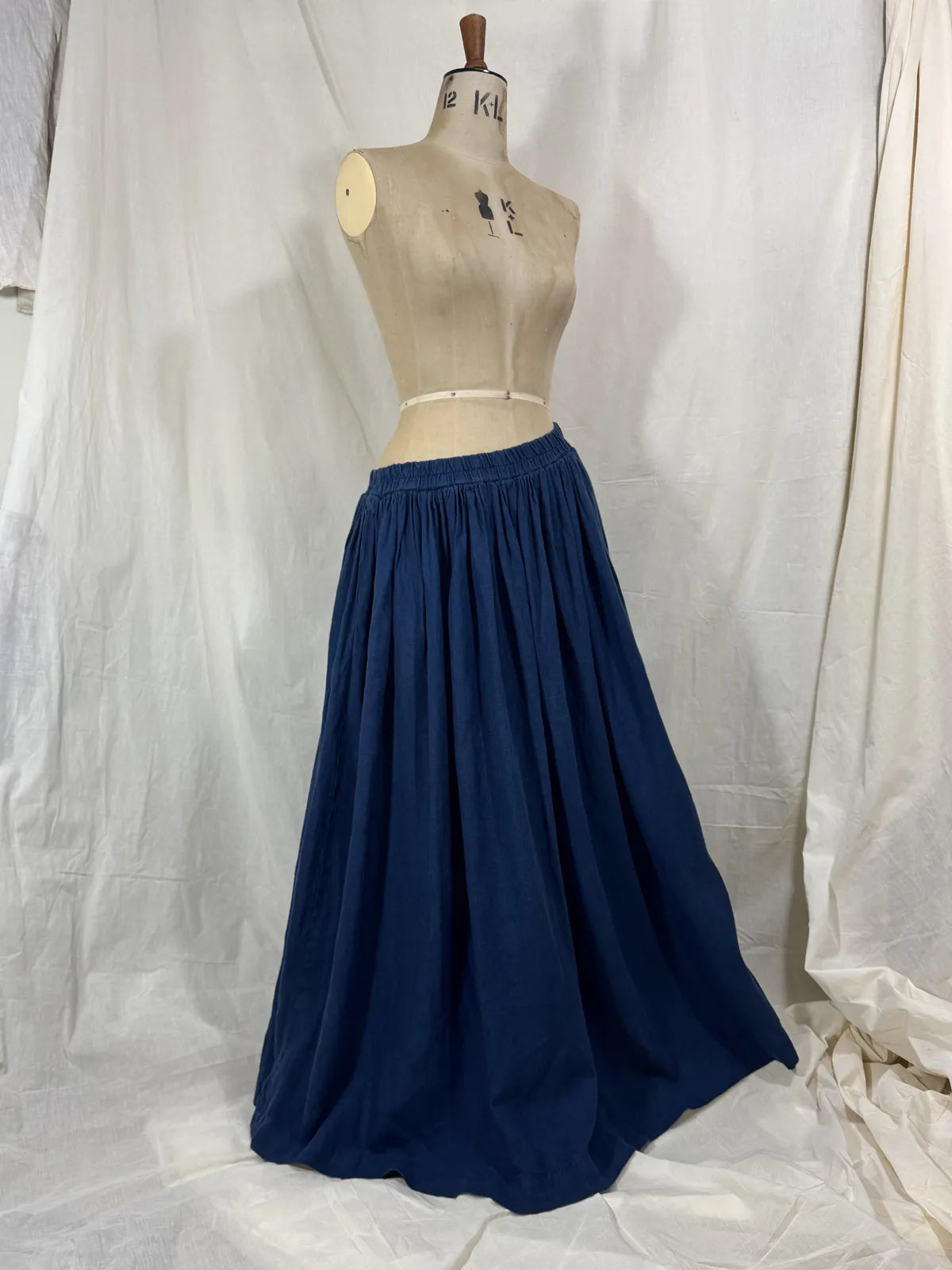 Navy blue skirt on a mannequin against a white background