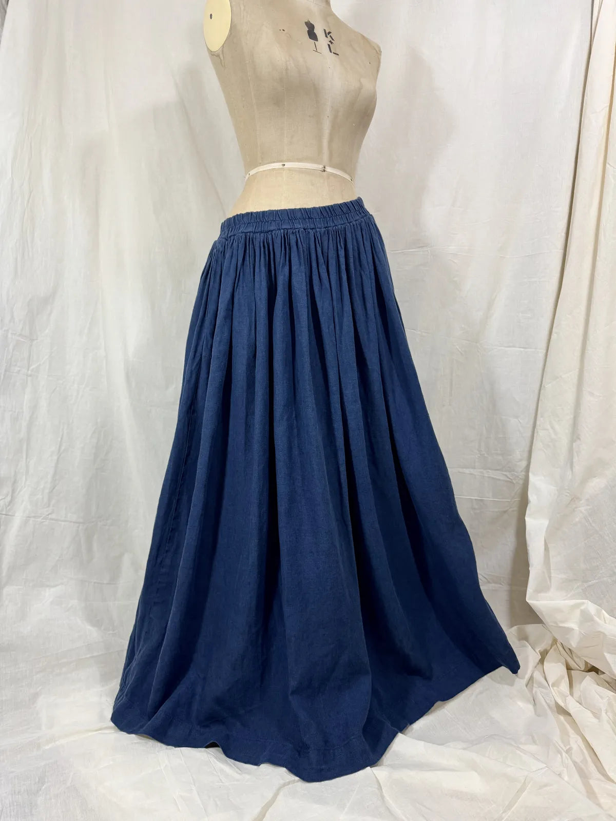 Navy blue skirt on a mannequin against a white background