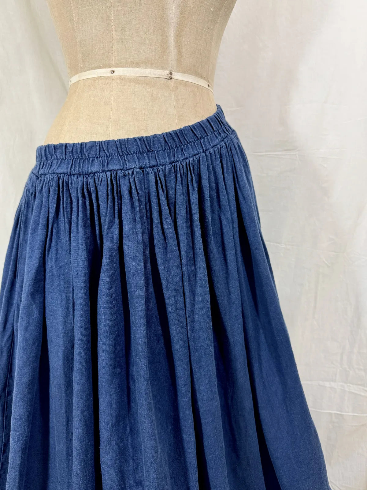Blue skirt on a mannequin against a white background