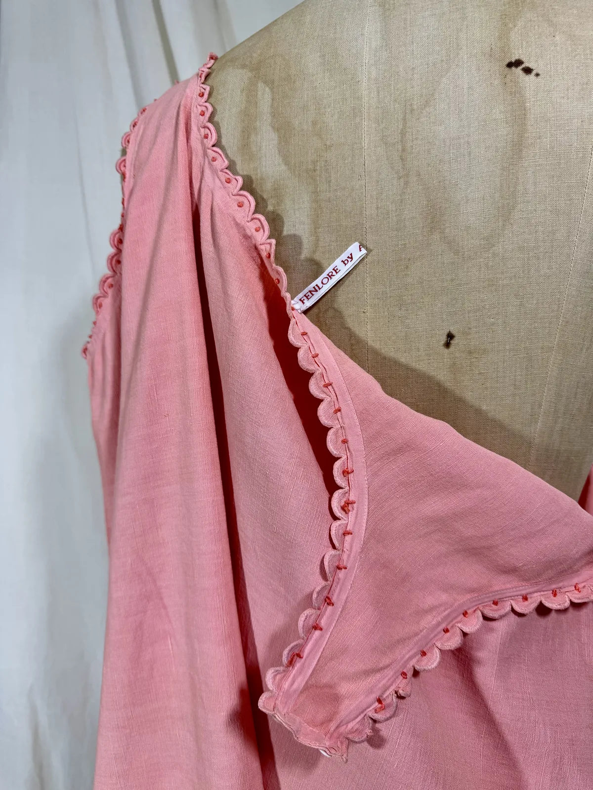 Victorian pink linen embroidered dress against white background