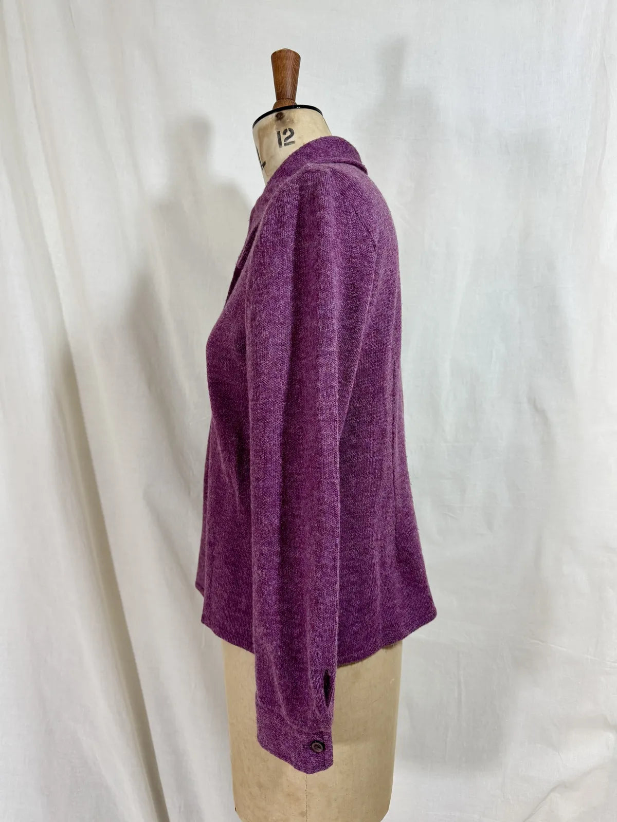 Purple wool cardigan on a mannequin with a white background