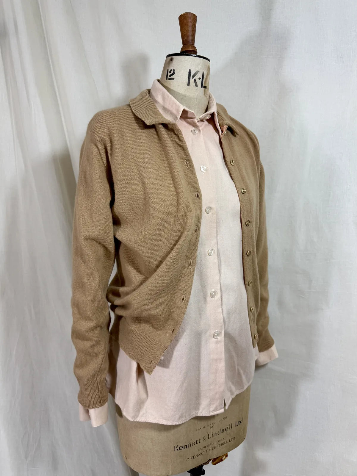 Brown cardigan against white backdrop