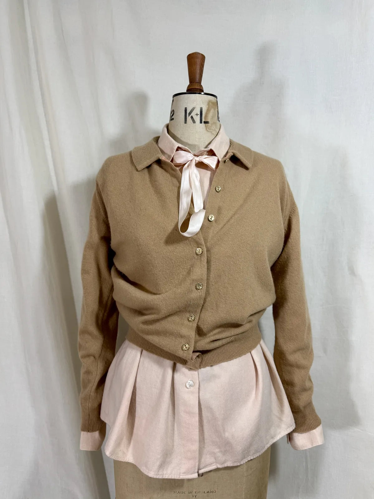 Brown cardigan against white backdrop