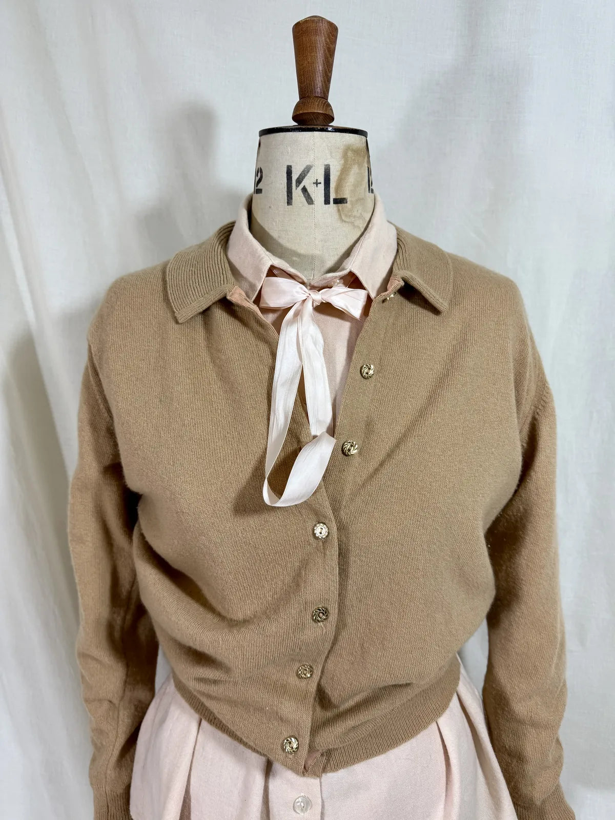 Brown cardigan against white backdrop