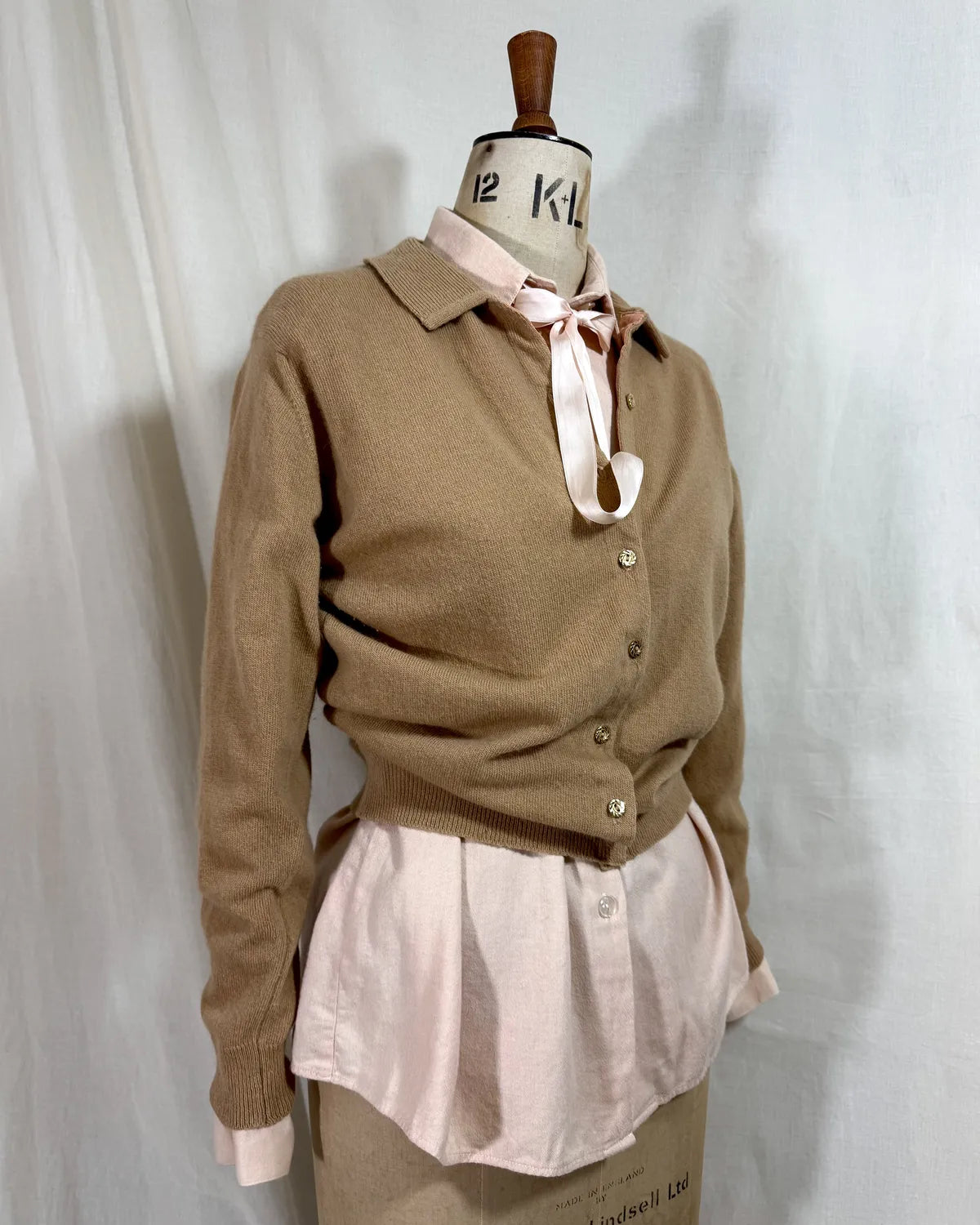 Brown cardigan against white backdrop