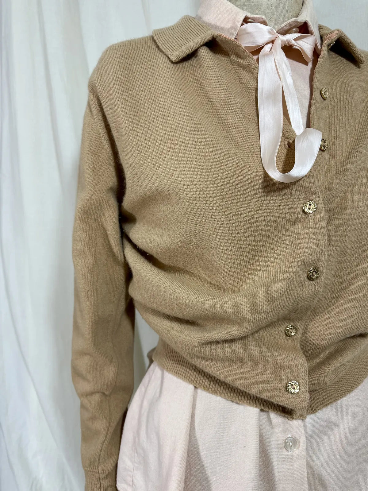 Brown cardigan against white backdrop