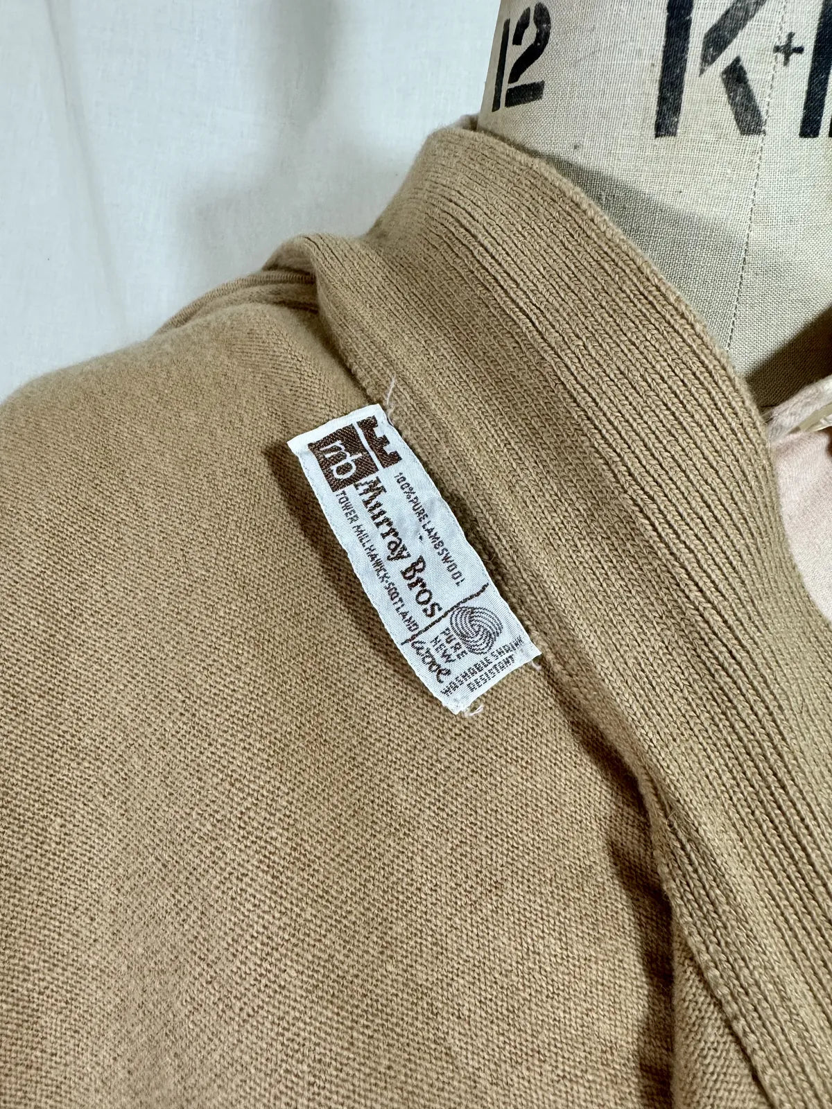 Brown cardigan against white backdrop