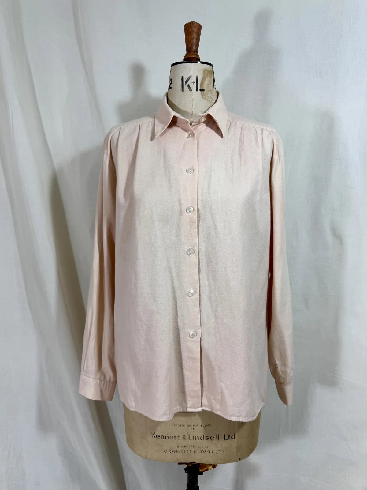 Pink naturally dyed shirt against a white background