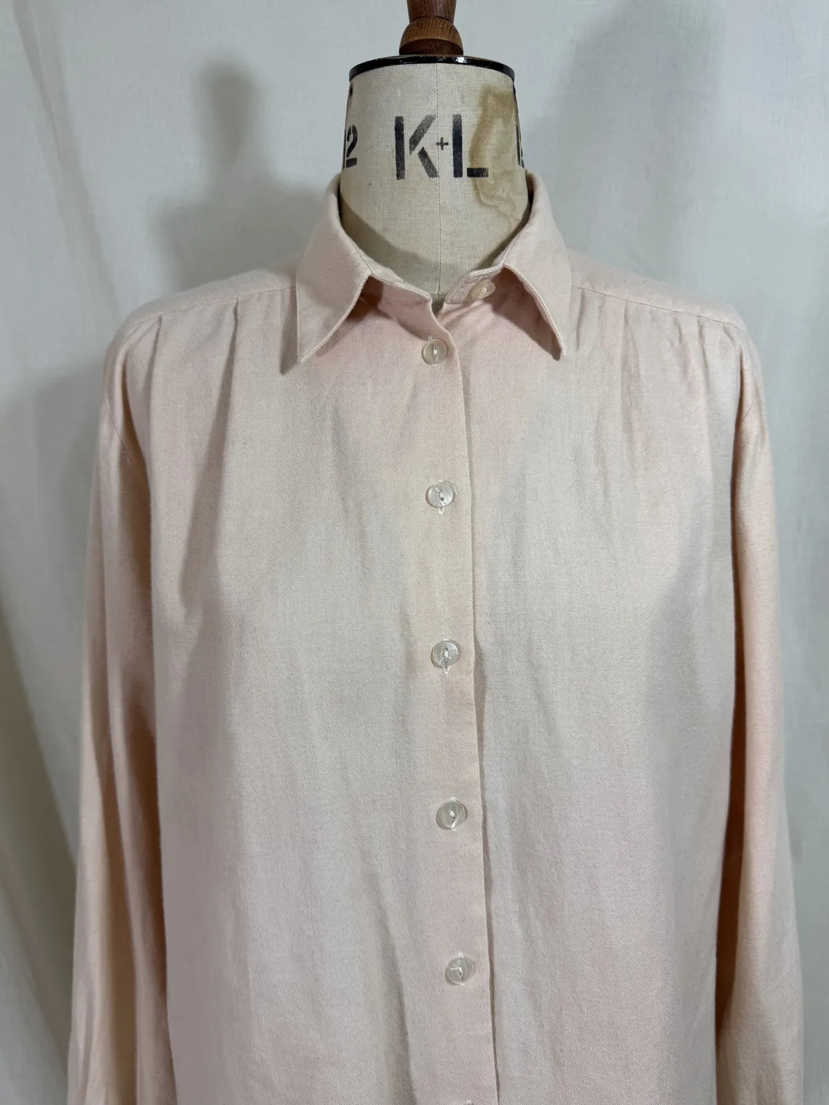 Pink naturally dyed shirt against a white background