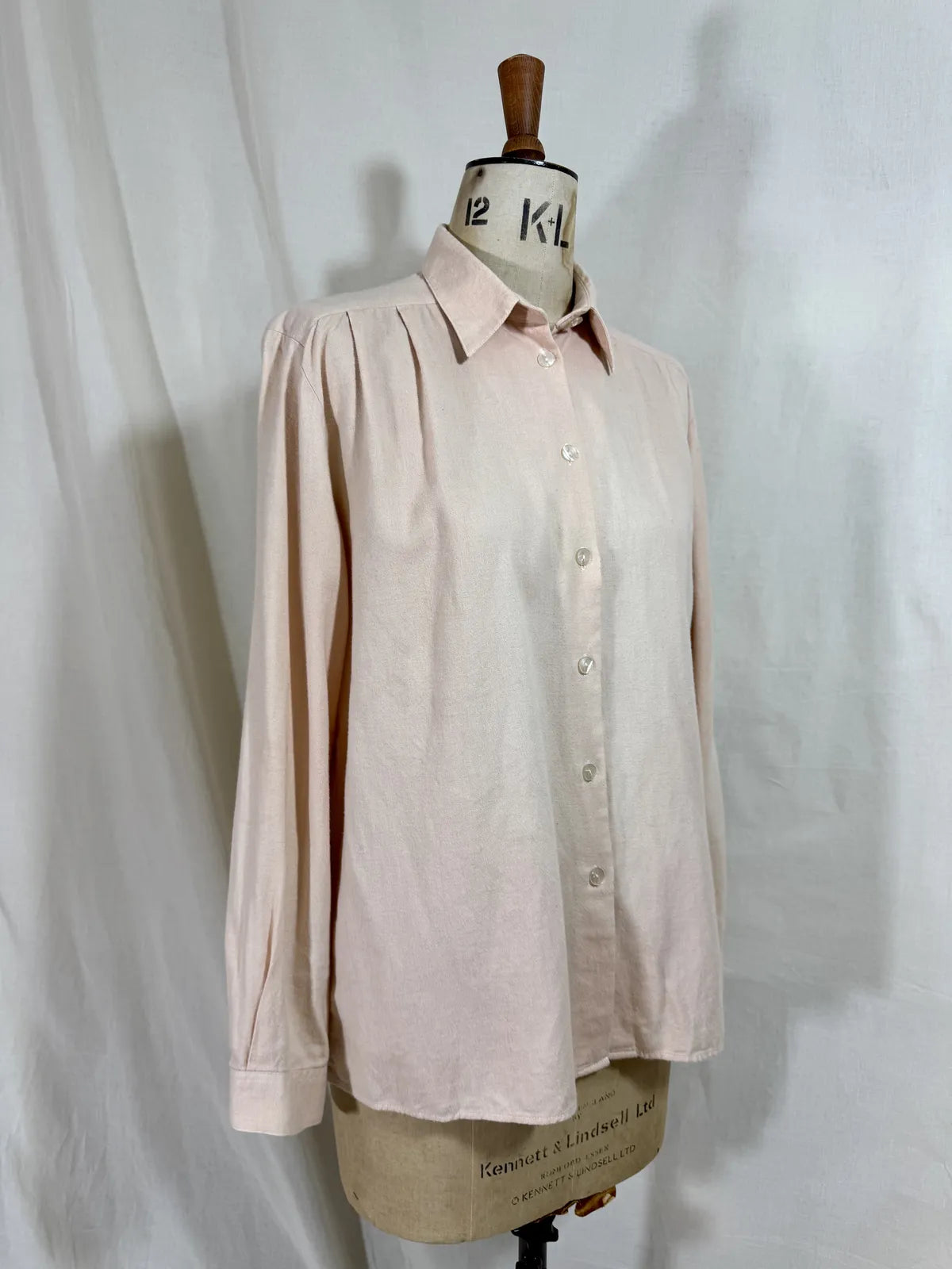Pink naturally dyed shirt against a white background