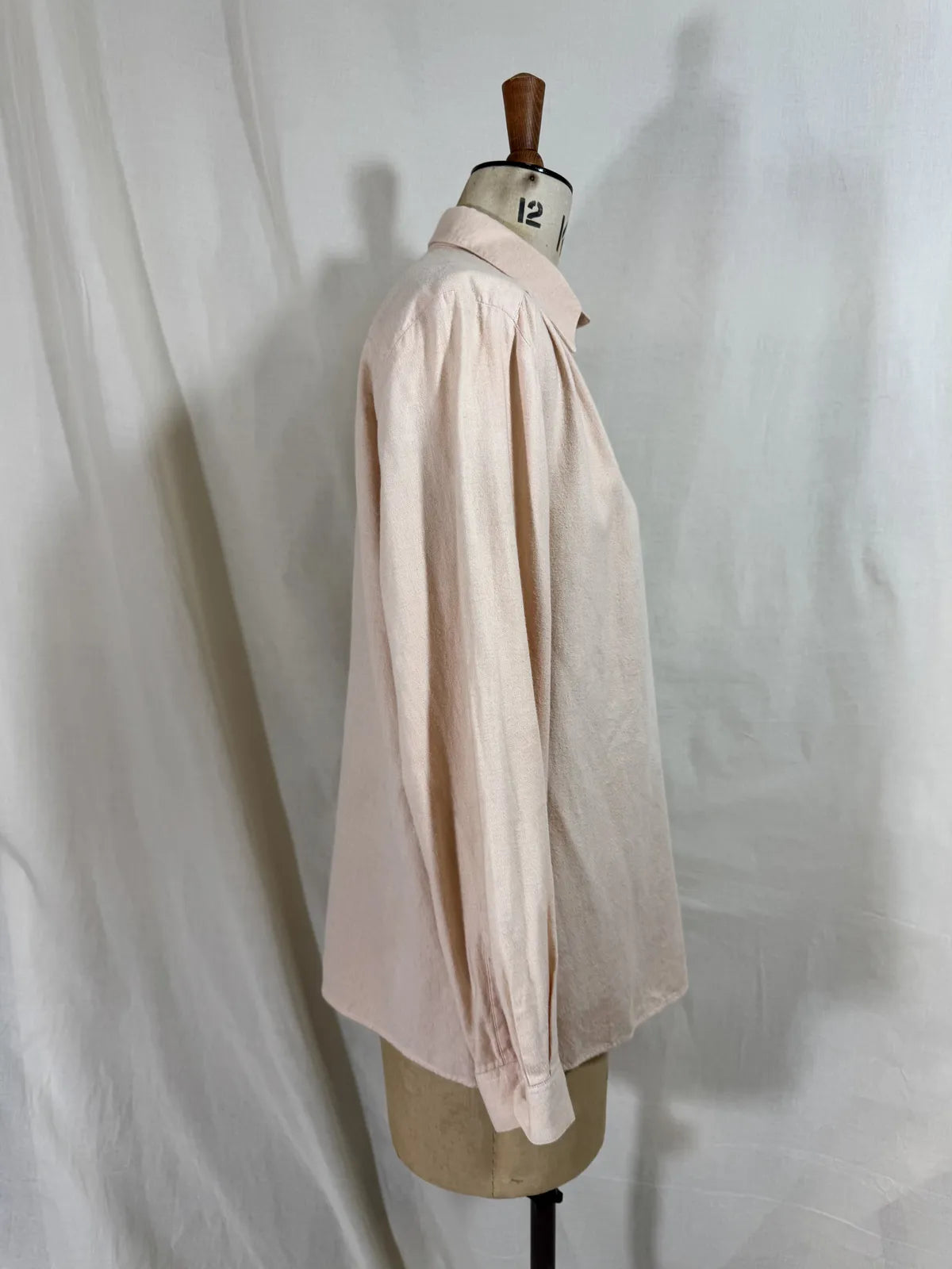 Pink naturally dyed shirt against a white background