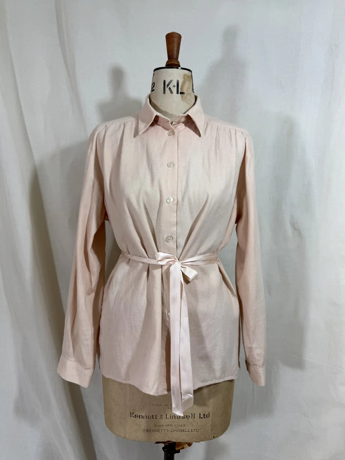 Pink naturally dyed shirt against a white background