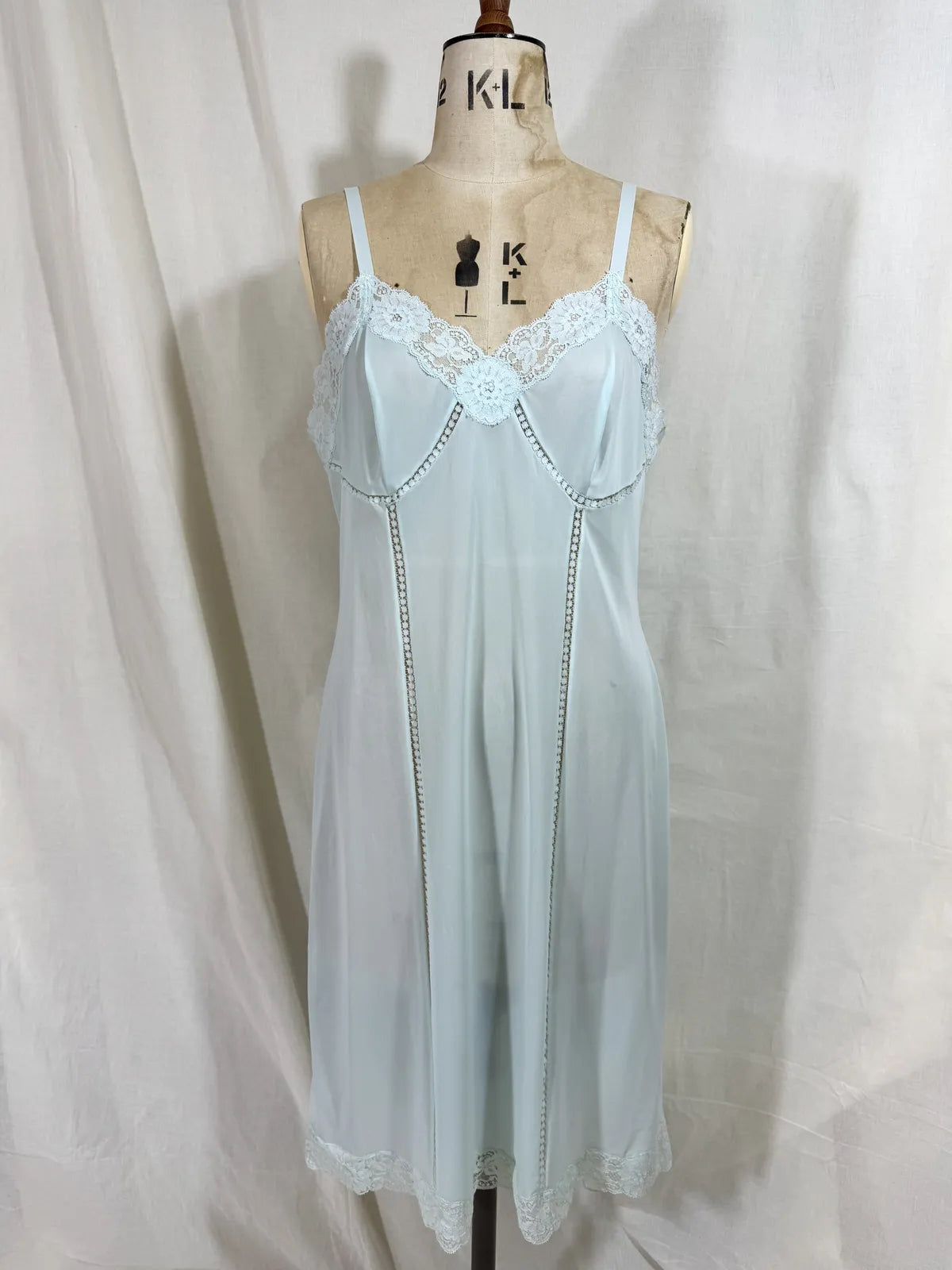 Light blue slip dress on a mannequin against a white background