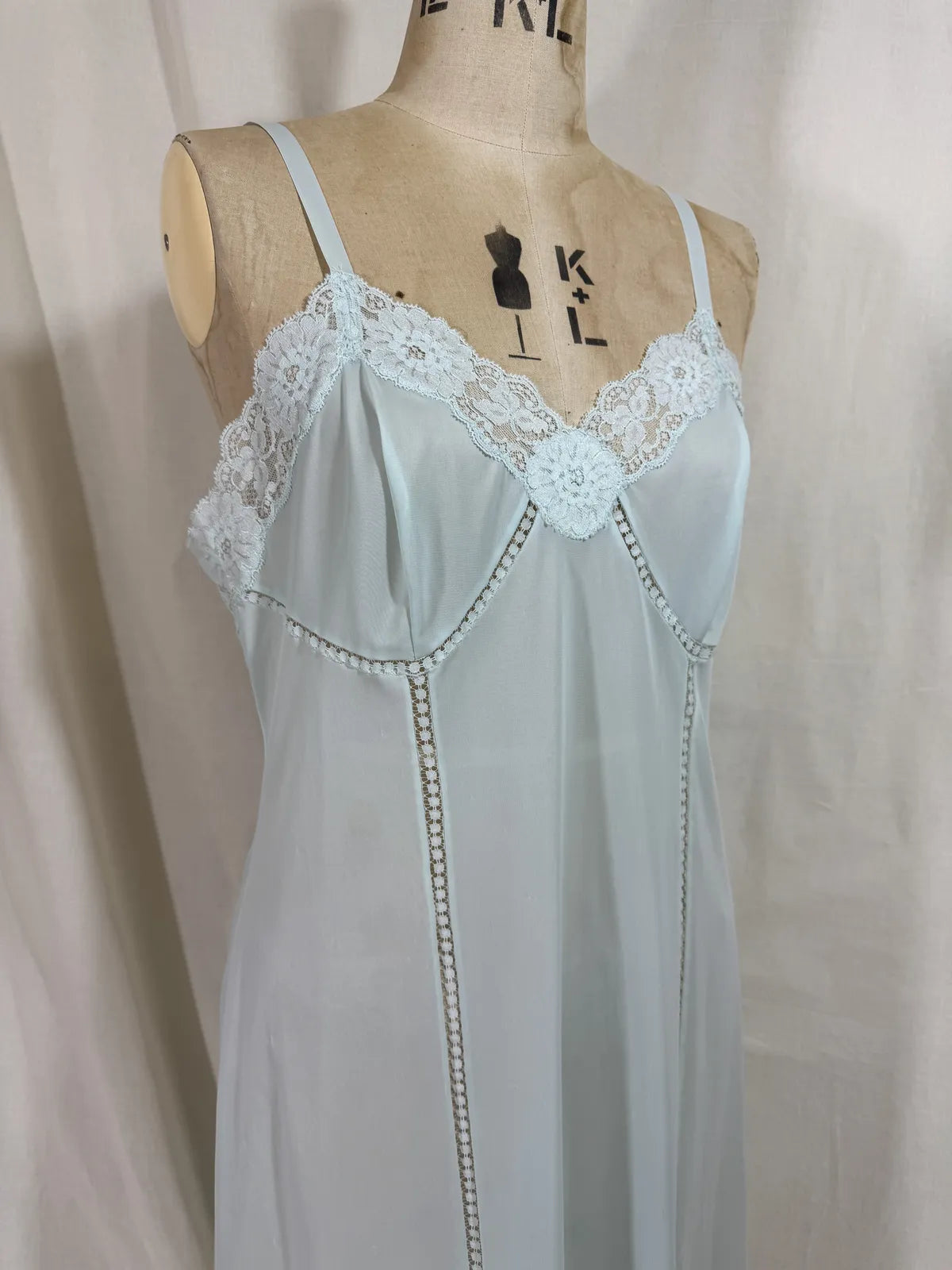 Light blue slip dress on a mannequin against a white background