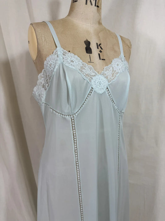 Light blue slip dress on a mannequin against a white background