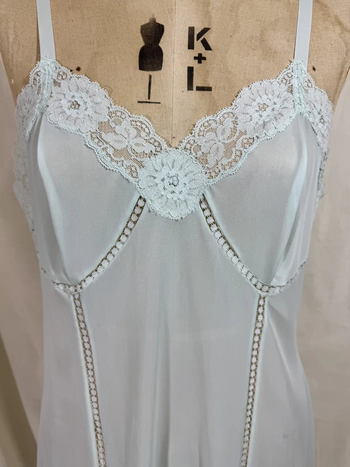 Light blue slip dress on a mannequin against a white background