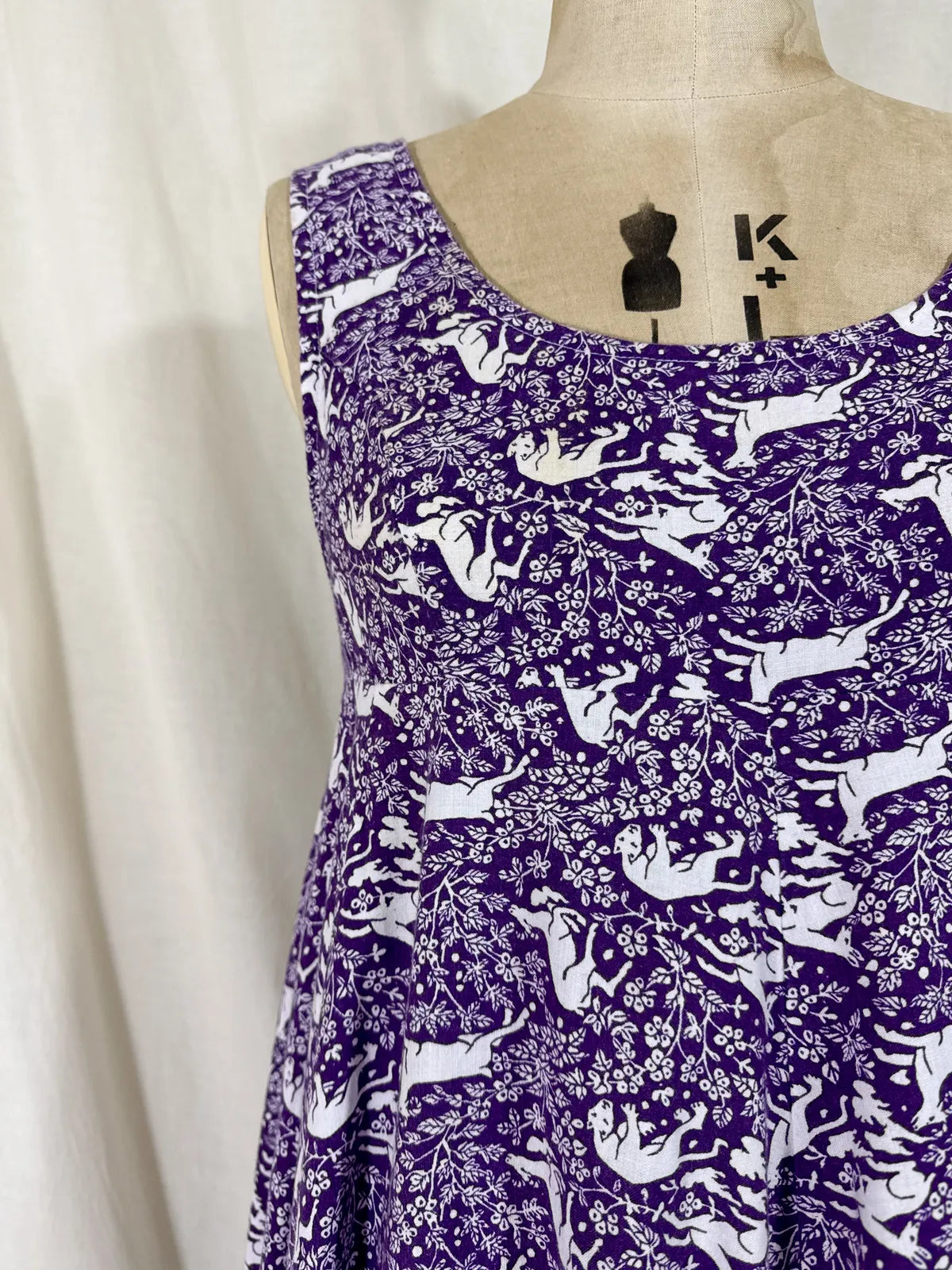 Purple maxi dress with lion and deer print on mannequin 