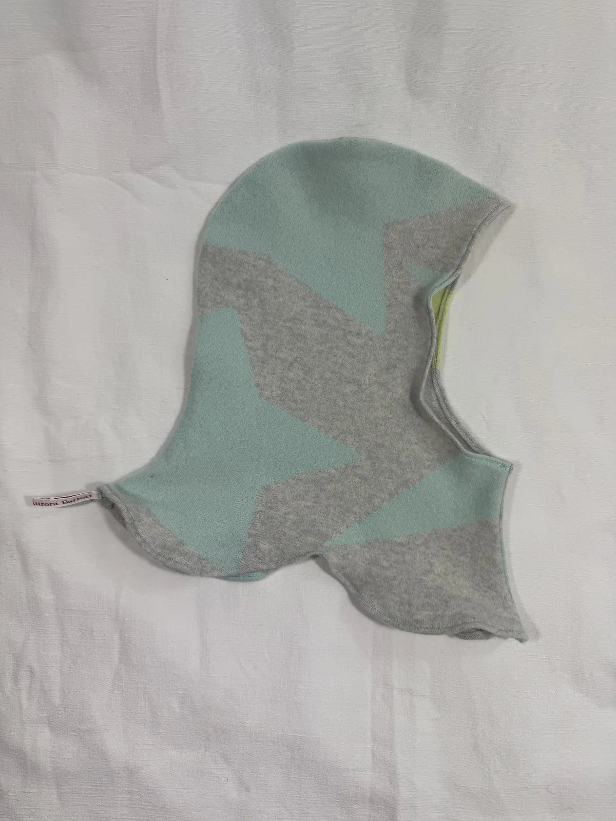 handmade turquoise geometric cashmere hood on white background