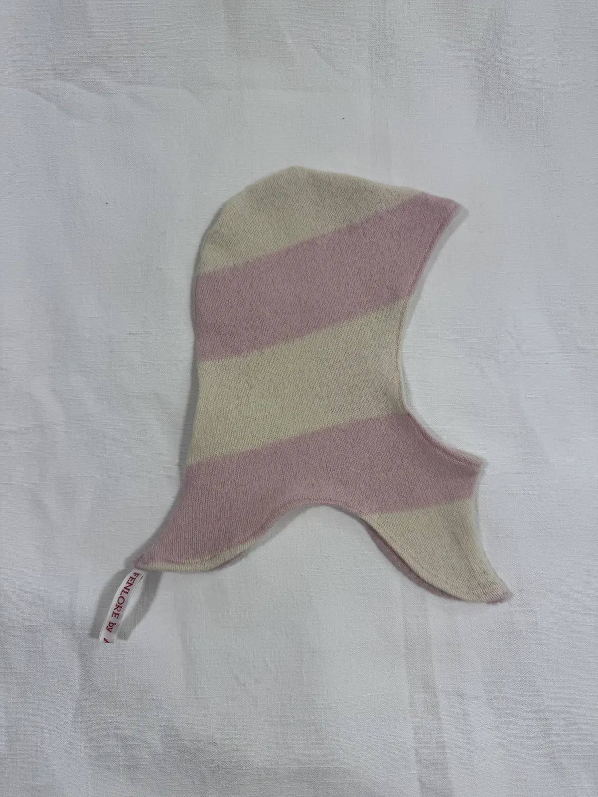 Pink striped cashmere hood for infant on a white background