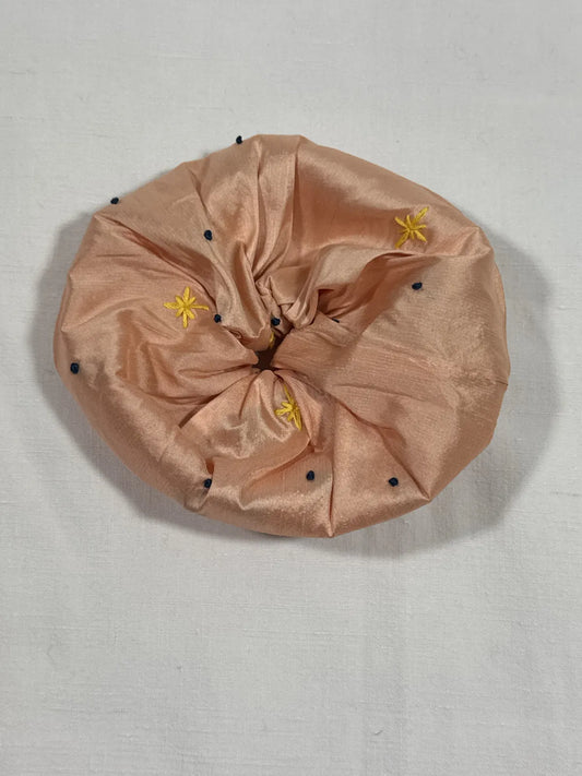 Apricot pink large scrunchie with hand embroidery against white background