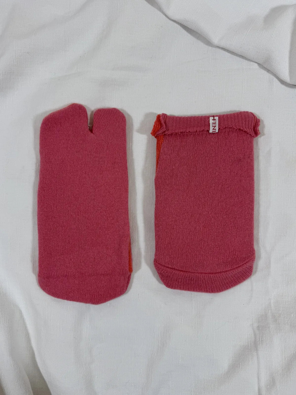 cashmere tabi bedsocks in pink and orange on a white backdrop