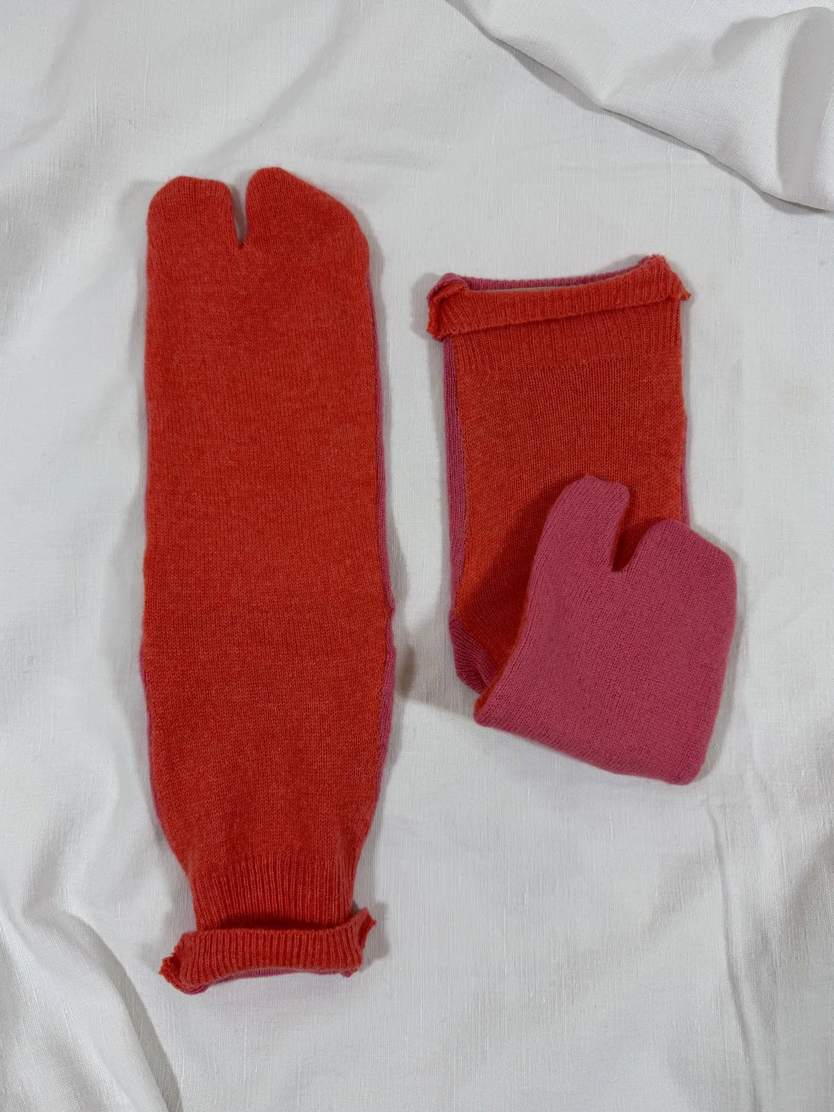 cashmere tabi bedsocks in pink and orange on a white backdrop