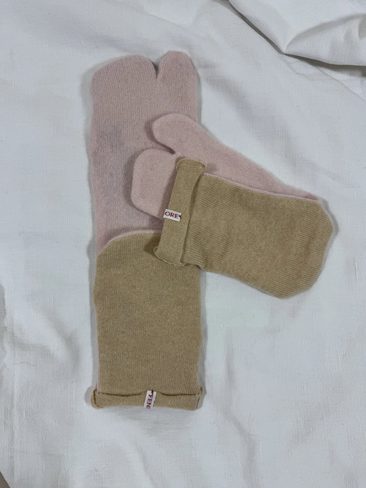 cashmere tabi bedsocks in pink and beige on a white backdrop