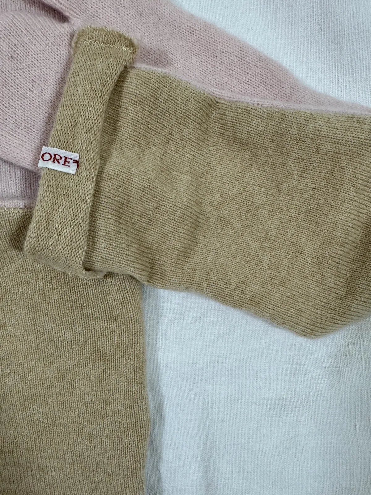 cashmere tabi bedsocks in pink and beige on a white backdrop