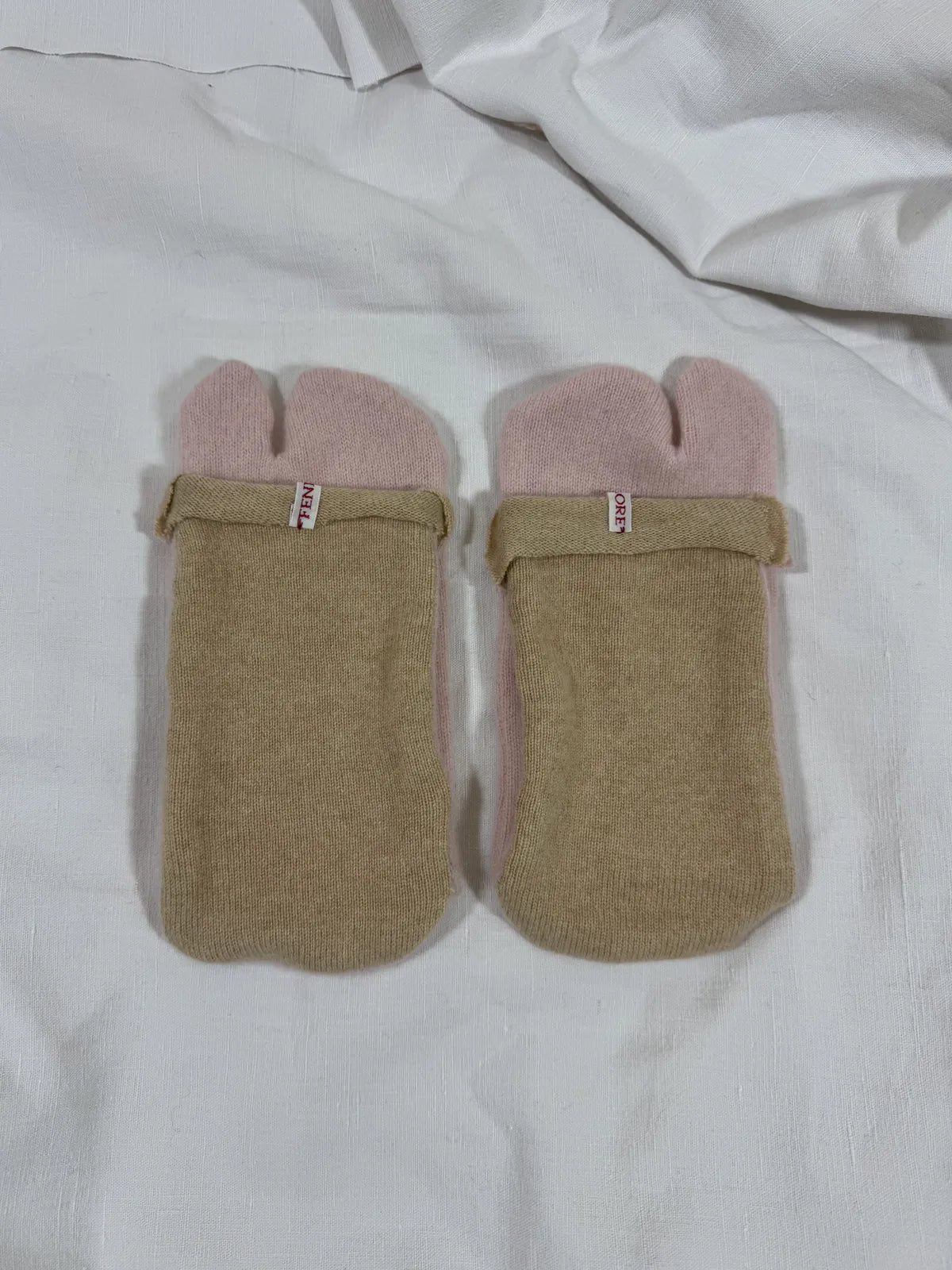 cashmere tabi bedsocks in pink and beige on a white backdrop