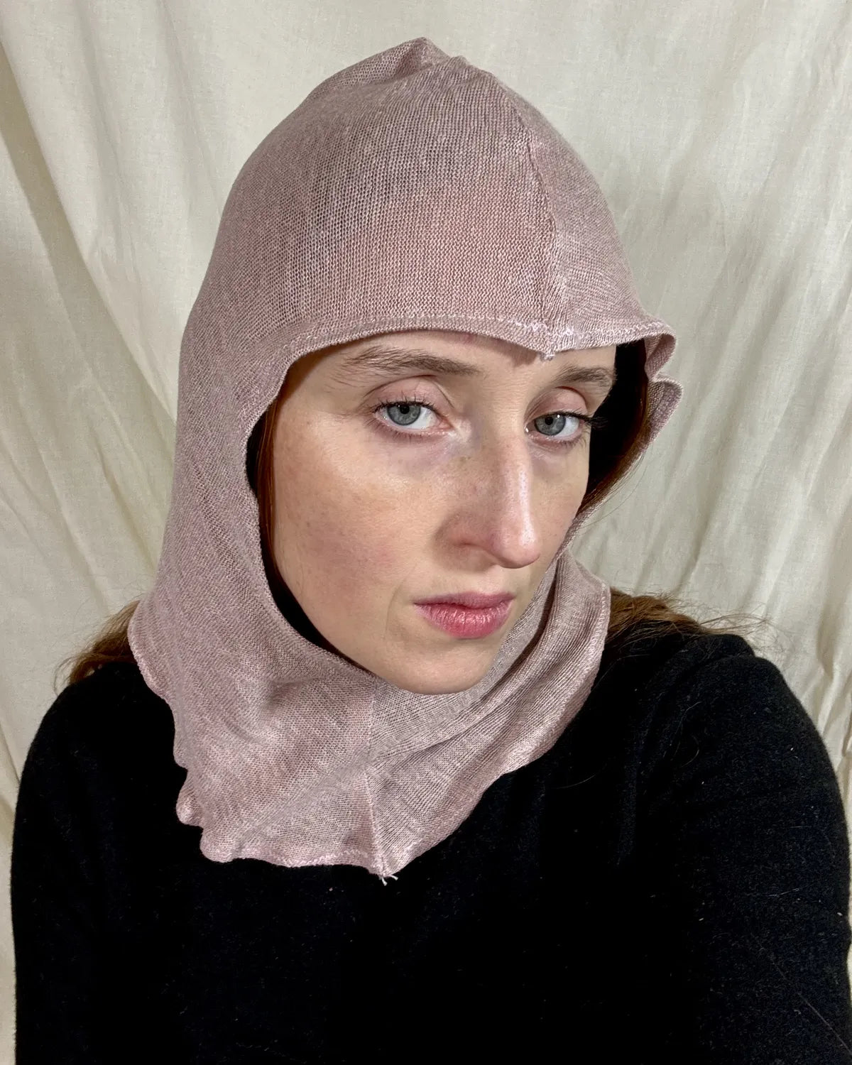 model wearing silk hood against white backdrop