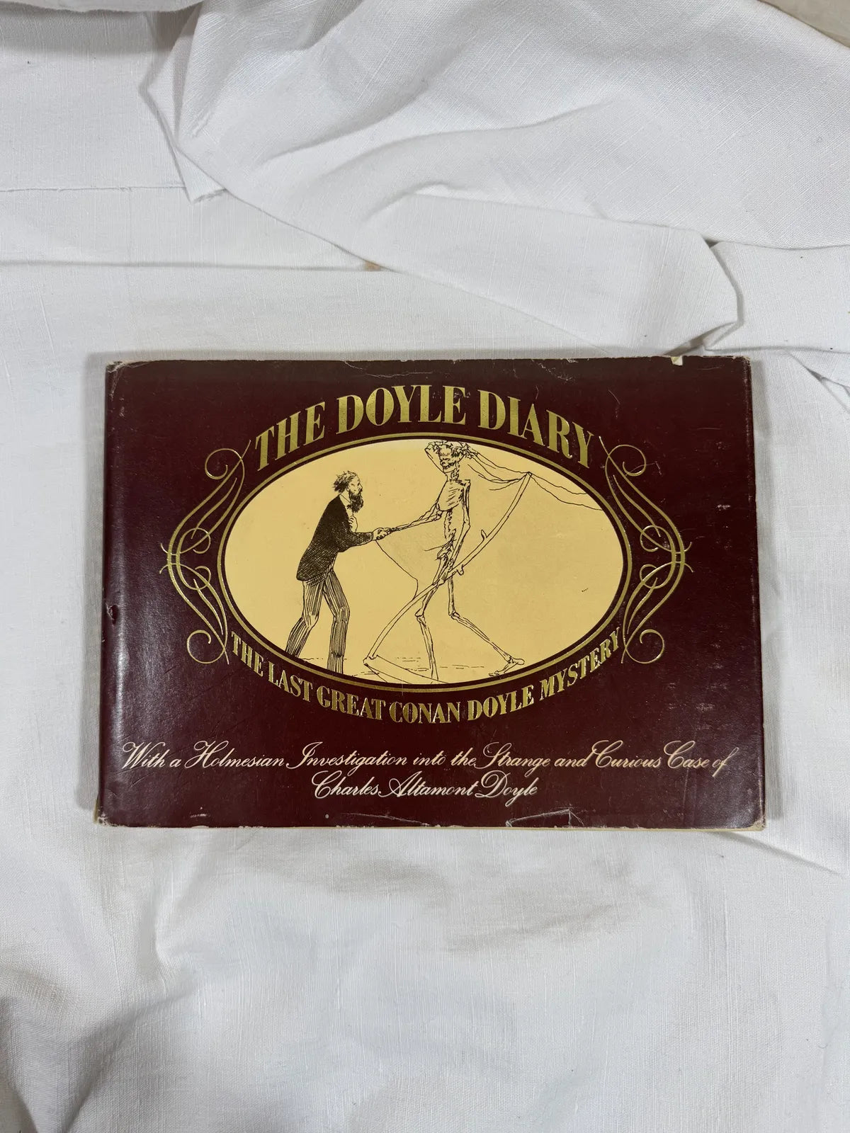 Brown hardback book with illustration against white background