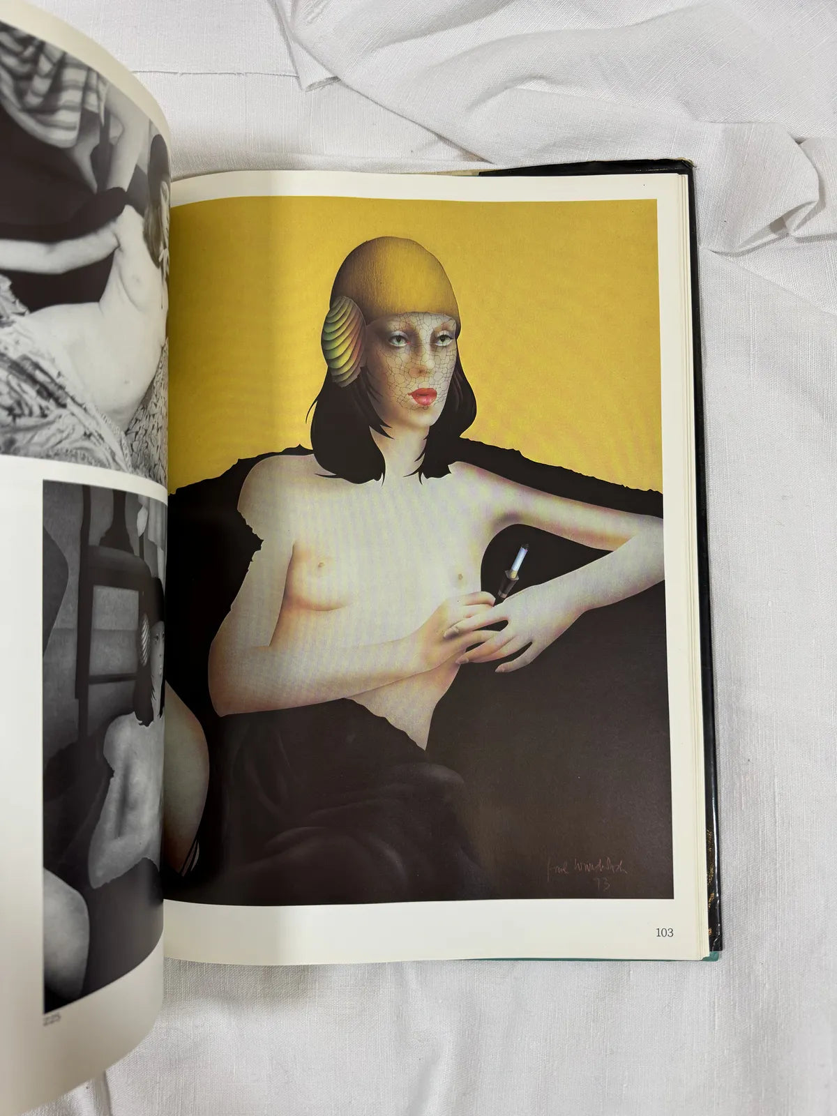 Open book displaying an art piece of a woman with a yellow helmet on a yellow background.